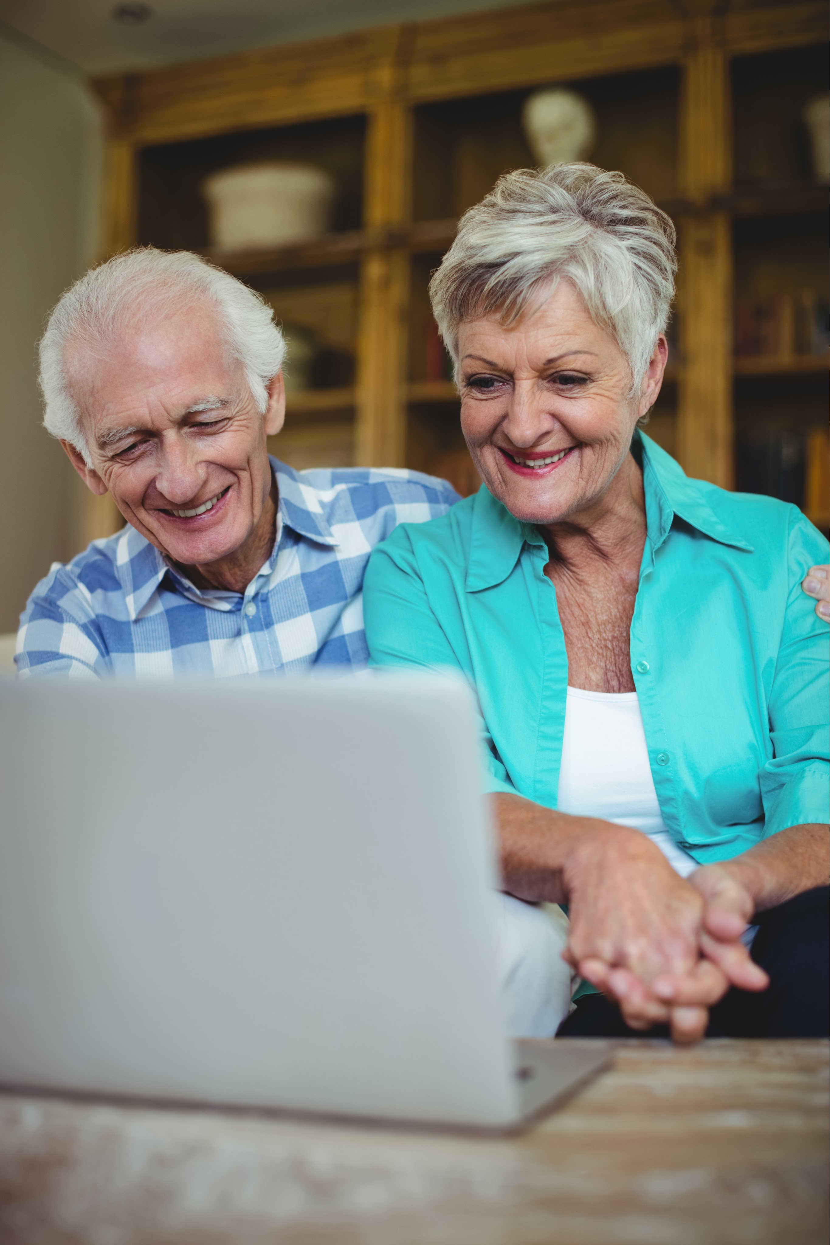 senior couple looking at laptop smiling alan amy