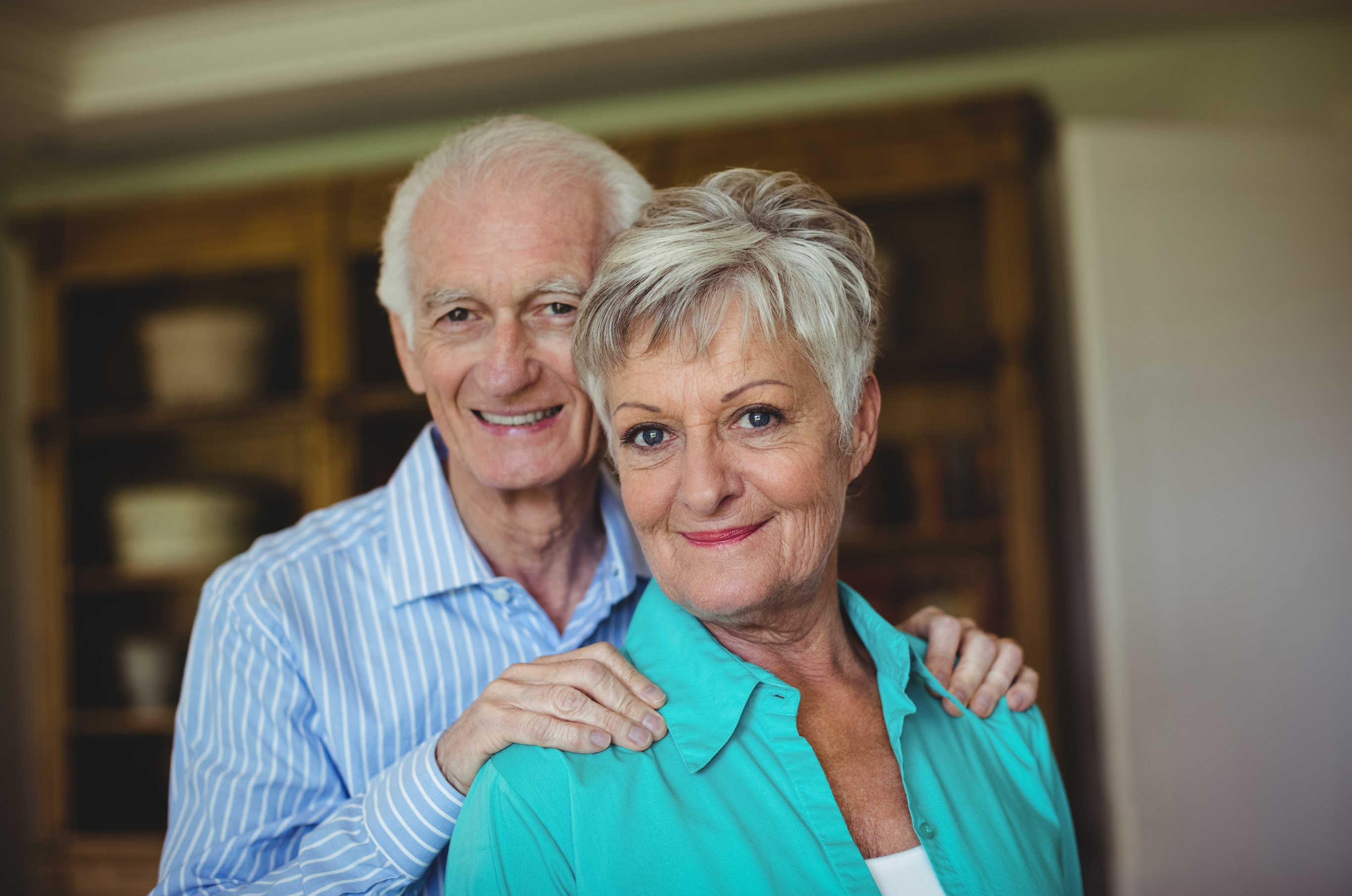 senior couple looking at camera smiling