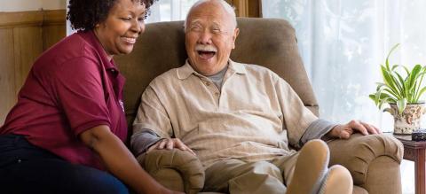 old asian man african american nurse seated laughing