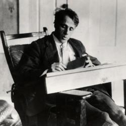 Robert Frost writing at desk ca 1920